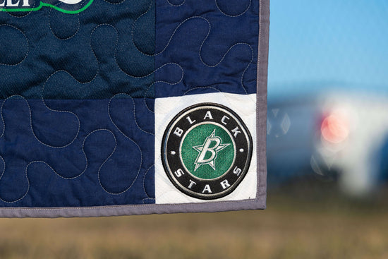 A close up photo of the custom cornerstone on a jerseyblanket